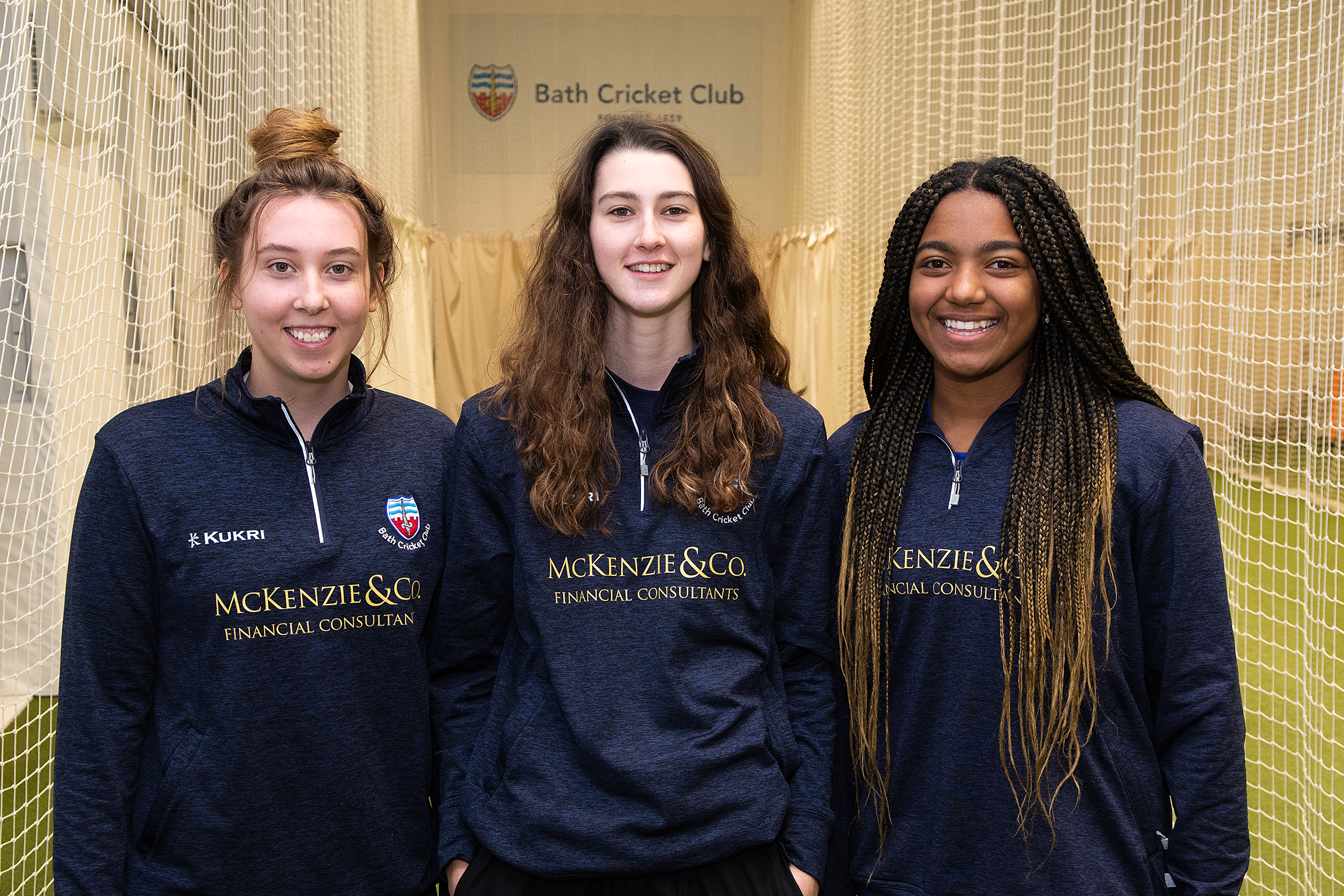 Photo of three female cricketers taken in an indoor training centre